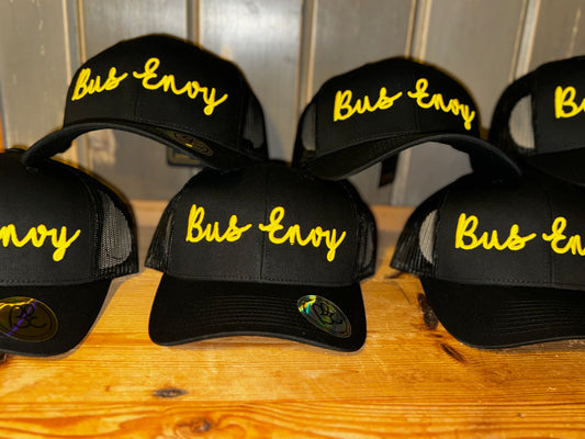 Snap Back Trucker Cap. All black. Yellow 3D logo