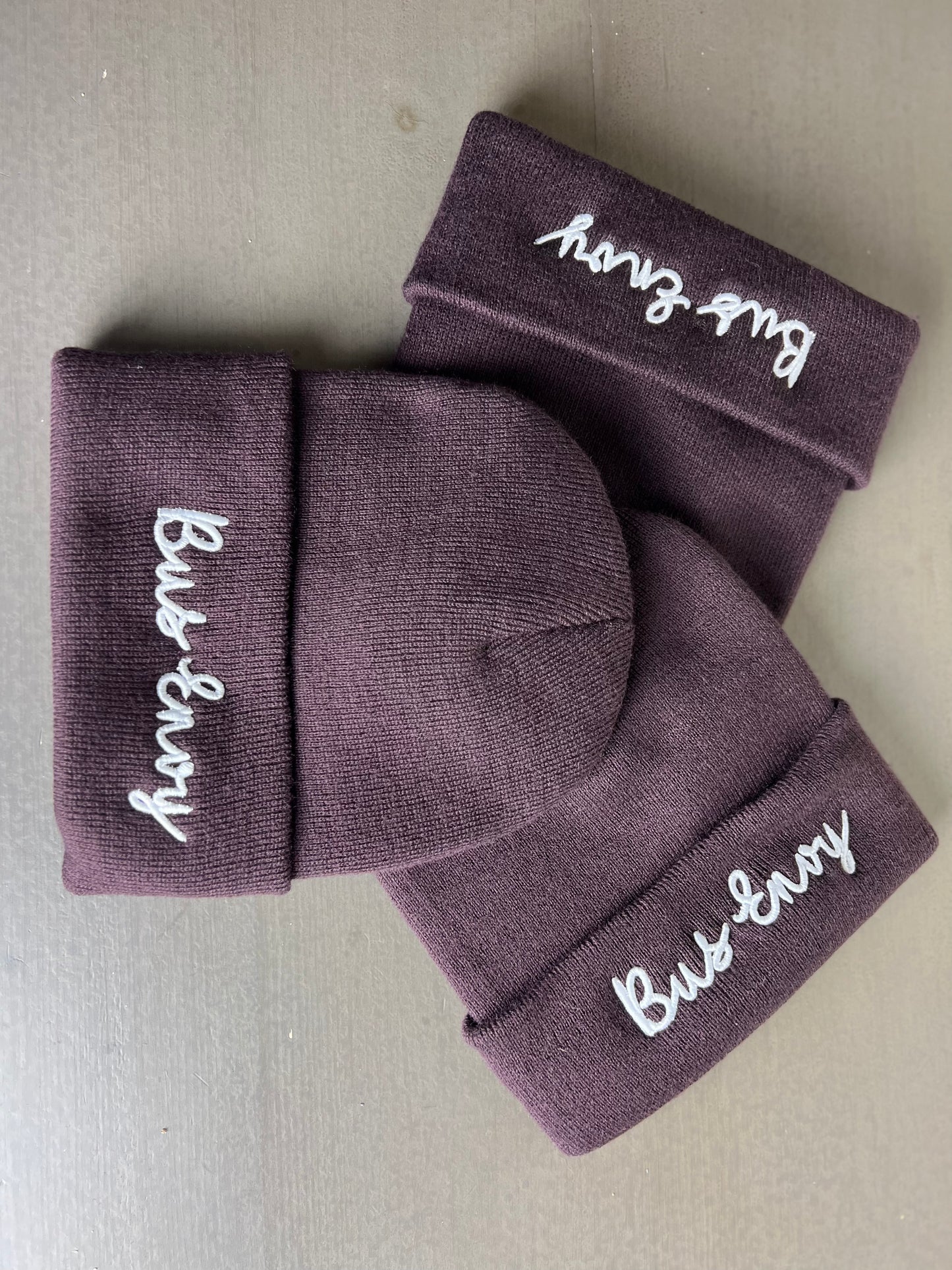 Unisex Bus Envy beanie. Plum & white
