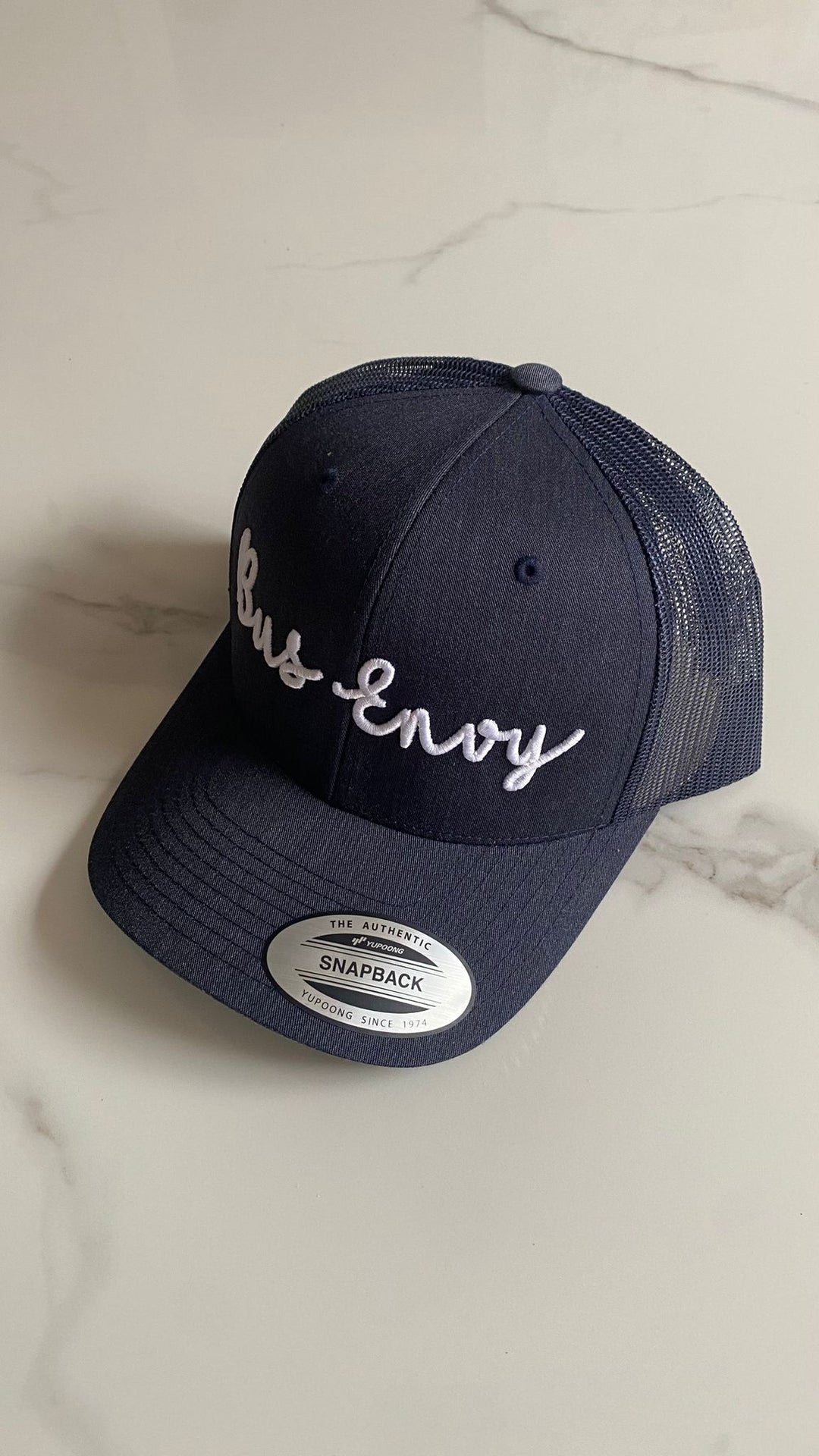 Snap Back Trucker Cap. Navy. White 3D logo