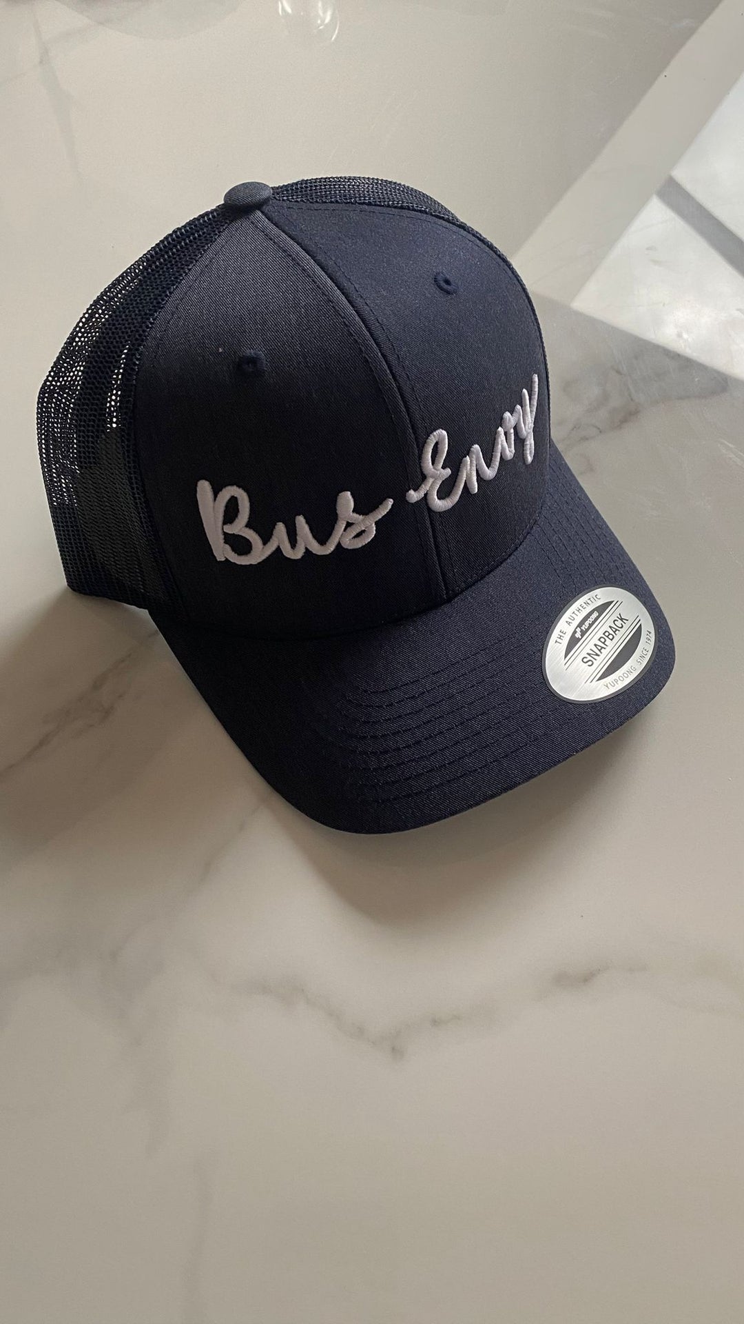 Snap Back Trucker Cap. Navy. White 3D logo