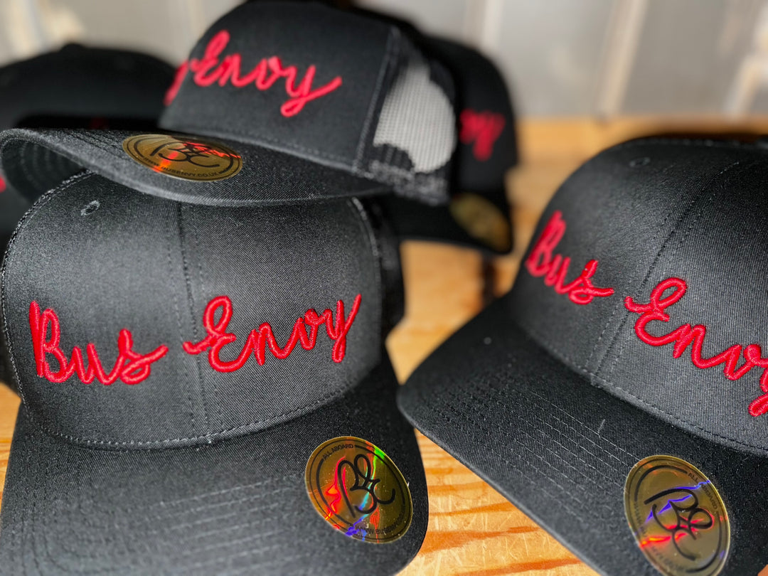 Snap Back Trucker Cap. All Black. Red 3D logo