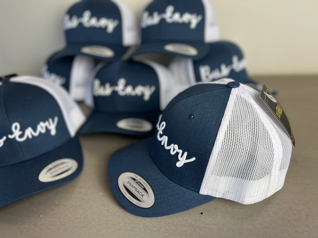 Snap Back Trucker Cap. Navy & white. White 3D logo
